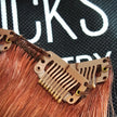 Close up of auburn snap clip on dark natural red human hair 7 piece clipset extensions