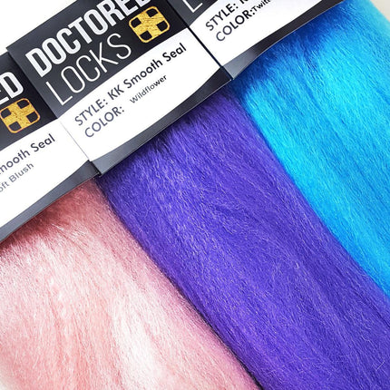 Light pink, purple, and turquoise blue Doctored Locks KK Smooth Seal Jumbo Braid packs 