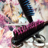 Blue and pink bristle backcombing brush with hair cutting tools