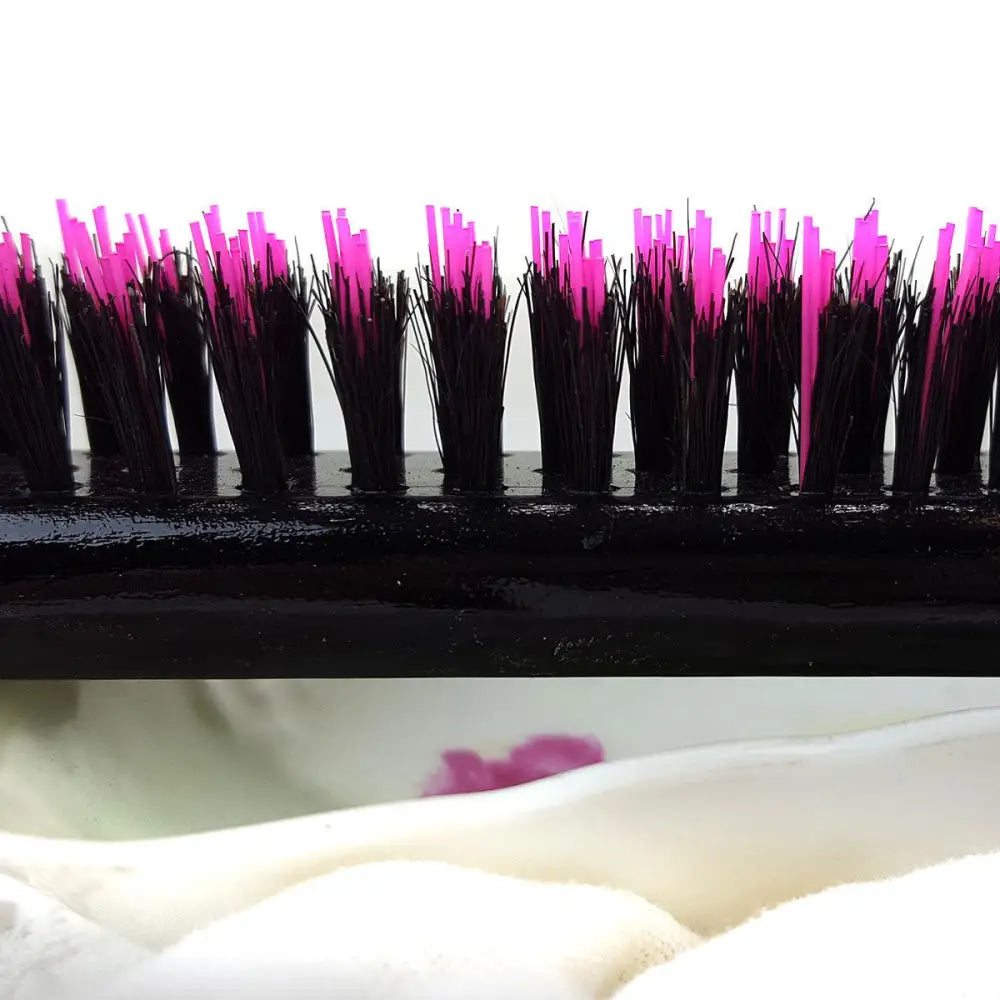 Close up of pink and black bristles on Little Wonder teasing hairbrush