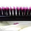 Close up of pink and black bristles on Little Wonder teasing hairbrush