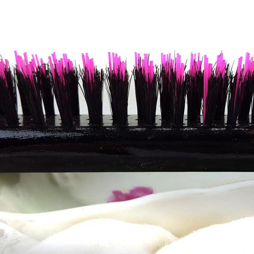 Close up of pink and black bristles on Little Wonder teasing hairbrush