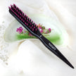 Purse size teasing backcombing brush with pointed end on floral dish