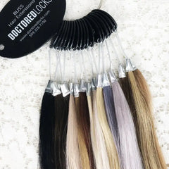 Full selection of color swatches attached to color ring with Doctored Locks tag on lace background