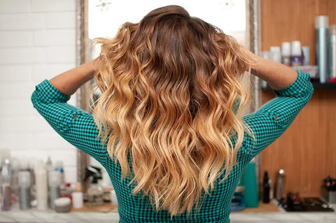 women showing off her new full set of hair extension hair