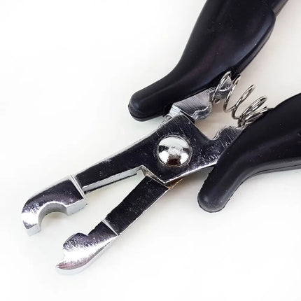 Close up of metal u-tip on pliers for making fusion hair extension tips
