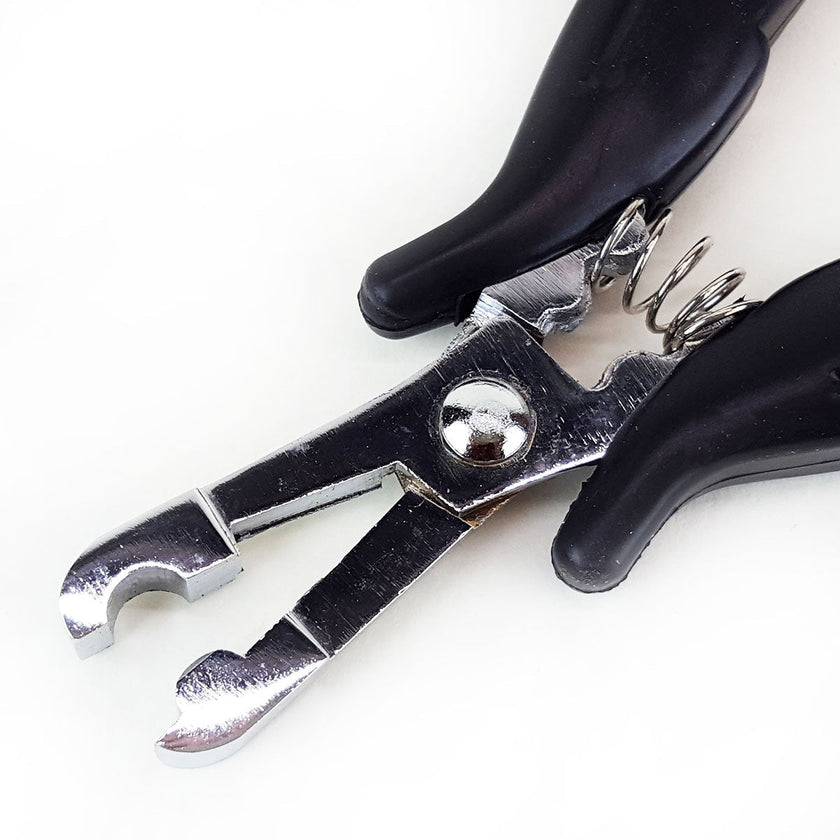 Close up of metal u-tip on pliers for making fusion hair extension tips