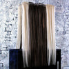 Dark brown and platinum blonde tape hair organized on professional hair extension stand