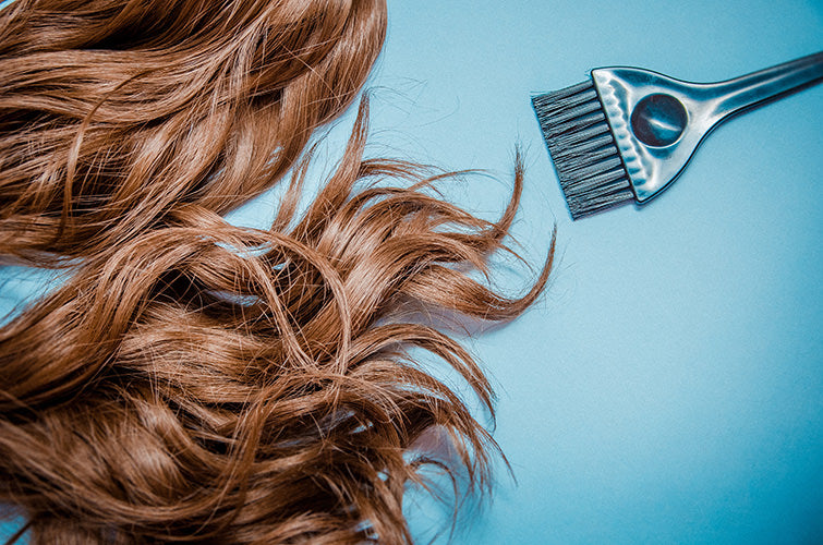 Extension hair on table with hair coloring brush