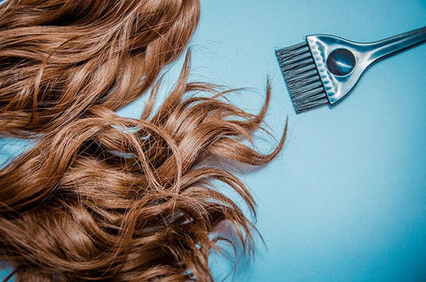 Extension hair on table with hair coloring brush
