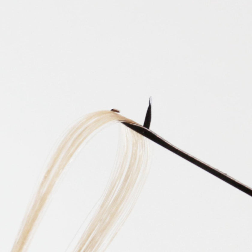 Loop of blond hair extensions in metal latch hook of nano microneedle