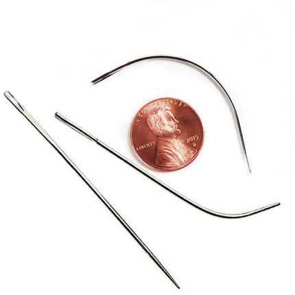 Metal straight, j curve, curved, and extra large curved weave needles for extensions installation next to penny for size comparison