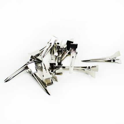 Several silver single pin curl clips on white background