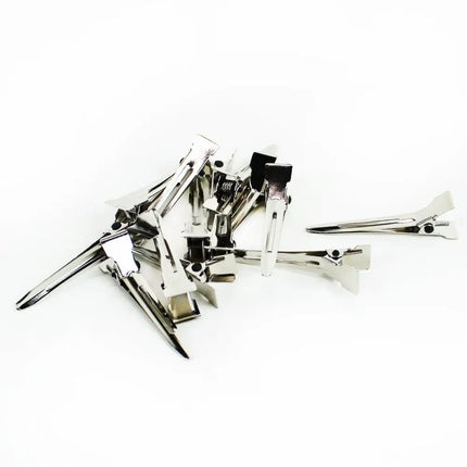 Several silver single pin curl clips on white background